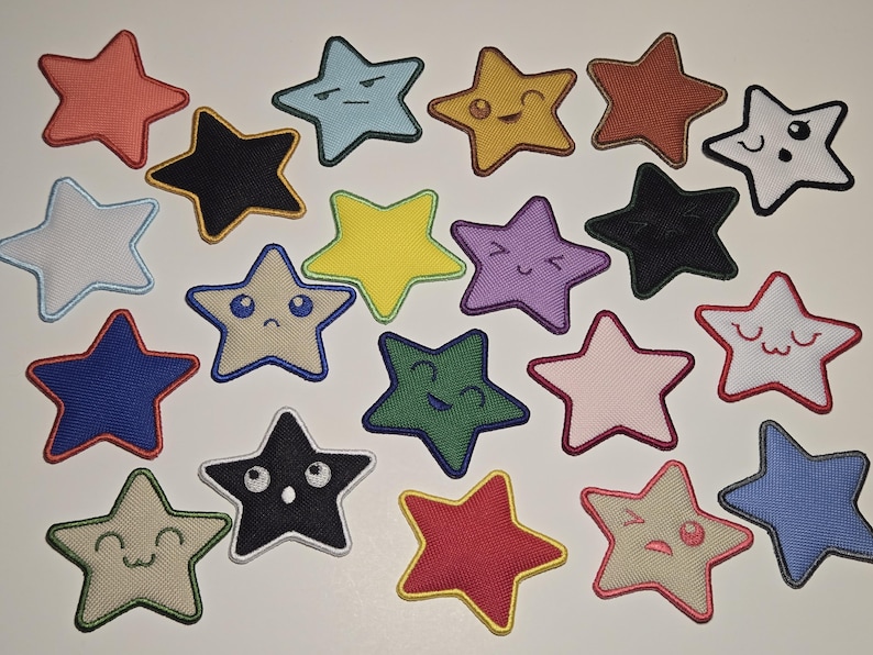 May include: A collection of embroidered star patches in various colors, including red, blue, yellow, and green. Each star features a different facial expression, such as smiling, winking, or frowning. The patches are likely for clothing or accessories.