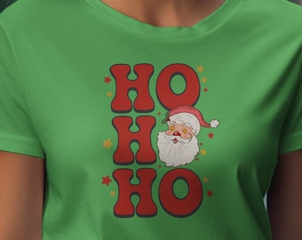 May include: Green t-shirt featuring a red and white Santa Claus graphic and the text "HO HO HO" in red letters with yellow stars.