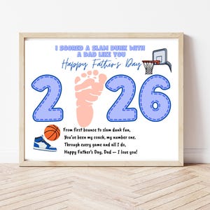 May include: A framed print with a basketball theme. The design includes the text "I scored a slam dunk with a dad like you Happy Father's Day" and the numbers "226" in blue. A basketball, a sneaker, and a footprint are also featured.