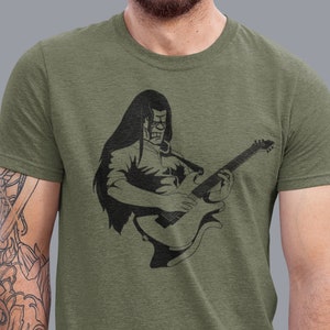 May include: A green t-shirt with a black graphic of a person playing a guitar.