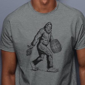 Bigfoot Beer Shirt, Cool Beer TShirt, Sasquatch Drinking Tee, Yeti Graphic Pub Gift, Bigfoot Carrying Beer T-Shirt, Funny Meme Gift