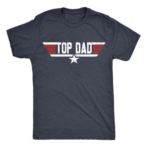 May include: A navy blue t-shirt featuring the text "TOP DAD" in white, red, and a star graphic. The design is styled after a classic movie logo. The shirt has a crew neck and is made of a soft material.