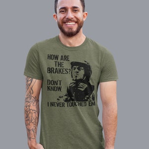 May include: A green t-shirt with a black graphic of a man in a helmet with the text "How are the brakes? Don't know. I never touched 'em."