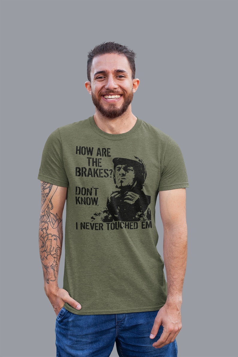 May include: A green t-shirt with a black graphic of a man in a helmet with the text "How are the brakes? Don't know. I never touched 'em."