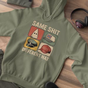 May include: Olive green hoodie with the text "SAME SHIT DIFFERENT HAT" and four images of different hats. A matching beanie, black shoes, and headphones are also visible.