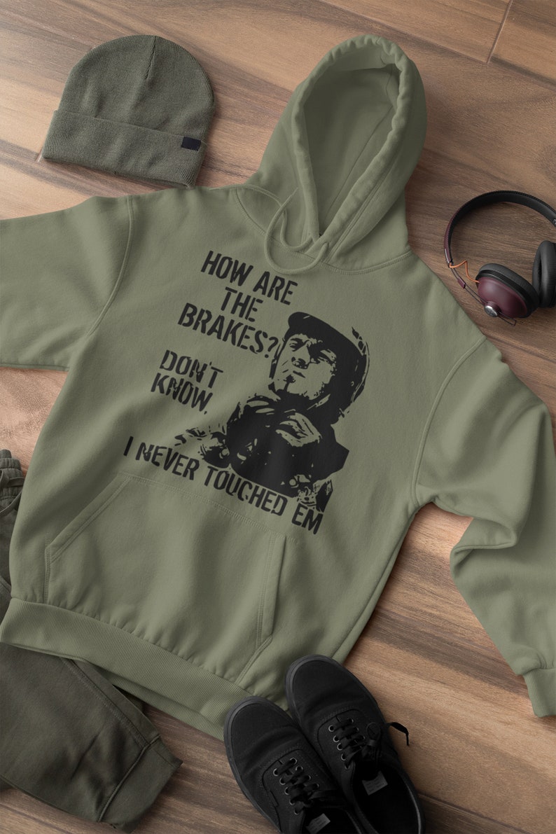 May include: A green hooded sweatshirt with a black graphic print of a man in a racing helmet. The text on the graphic reads "How are the brakes? Don't know. I never touched em."