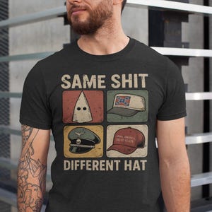 May include: Black t-shirt with the text "SAME SHIT DIFFERENT HAT" and four images of different hats. The hats include a white hood, a Confederate flag cap, a military hat, and a red "Make America Great Again" cap.