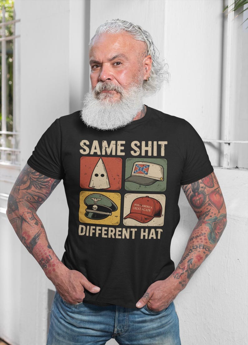 May include: Black t-shirt with the text "SAME SHIT DIFFERENT HAT" and four images of different hats. The hats include a white hood, a hat with a Confederate flag, a military hat, and a red "Make America Great Again" hat.