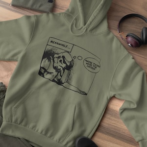 May include: A green hooded sweatshirt with a black and white comic strip graphic featuring a character with the text "MEANWHILE... MAYBE THOSE WERE THE Droids".