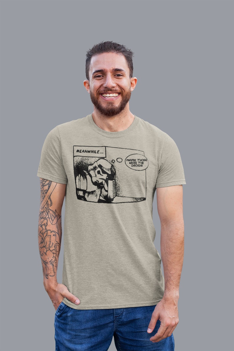 May include: A light gray t-shirt with a black and white comic strip graphic of a Stormtrooper saying "Maybe those were the droids". The comic strip is titled "Meanwhile..."