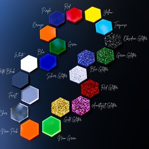 May include: A color chart of 20 different acrylic sheets in hexagon shapes. The colors include red, yellow, blue, green, orange, purple, turquoise, white, black, silver glitter, gold glitter, blue glitter, green glitter, red glitter, amethyst glitter, obsidian glitter, frost, clear, neon pink, and neon green.