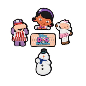 May include: A collection of five colorful Disney Doc McStuffins character charms. The charms include Doc McStuffins, a lamb, a snowman, and a hippo. The center charm is a bandage with the show's logo.