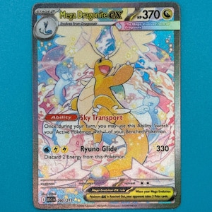 以下が含まれることがあります： ホログラフィックのメガドラゴンナイトEXポケモンカード。カードには、白と青の背景に、黄色とオレンジ色のドラゴンナイトが描かれています。「メガドラゴンナイトEX」と「スカイトランスポート」の文字があります。