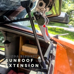 May include: A Honda Element sunroof extension mechanism featuring a black metal support rod and a silver-toned hinge assembly with a red accent piece. The text HONDA ELEMENT SUNROOF EXTENSION is printed in white over the orange vehicle body interior.