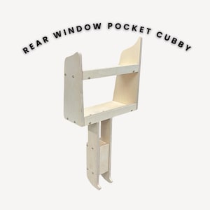 May include: A wooden rear window pocket cubby with two shelves. The cubby is made of plywood and has a light wood finish. It is designed to fit in the rear window of a vehicle.