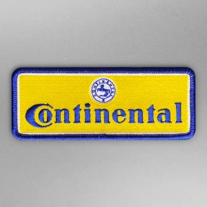 Könnte beinhalten: Ein gestickter Aufnäher mit dem Continental-Logo in Blau und Gelb, mit einem Pferd-und-Reiter-Emblem.