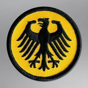 May include: A set of three ceramic mugs with a speckled, matte finish. The mugs are in shades of cream, light gray, and dark gray. Each mug has a simple, minimalist design, perfect for coffee or tea.