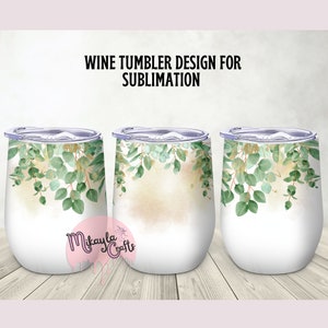 May include: Three white wine tumblers with clear lids, each adorned with a watercolor design of green eucalyptus leaves and gold accents. The text "WINE TUMBLER DESIGN FOR SUBLIMATION" is displayed above the tumblers.