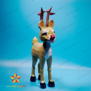 May include: A papercraft reindeer model with a brown body, white belly, and red antlers. The reindeer is standing on a blue background.