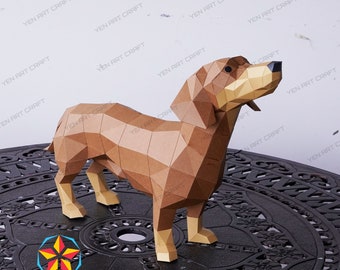 May include: A brown papercraft dachshund model, standing on a black metal table with a circular design. The model is made of folded paper and has a realistic appearance.