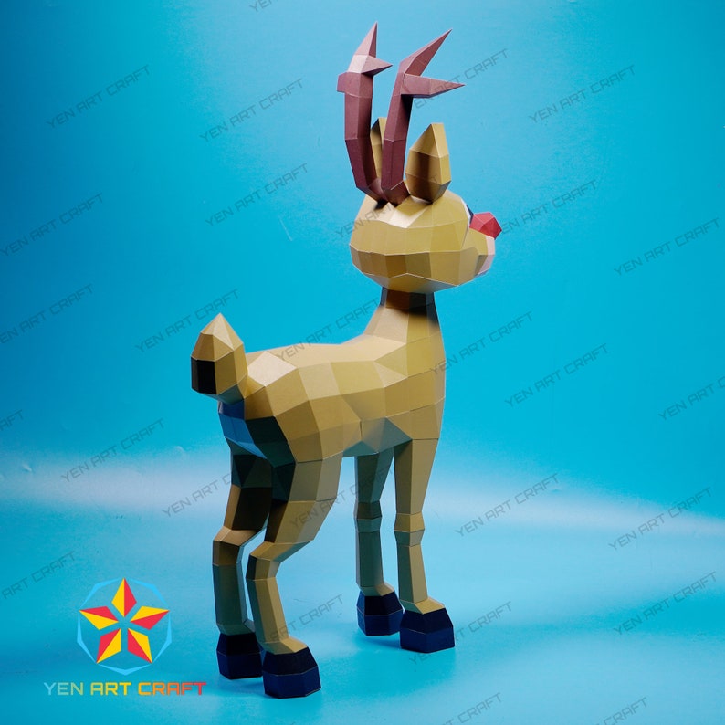 May include: A papercraft reindeer model with brown antlers and a red nose. The reindeer is standing on a blue background.