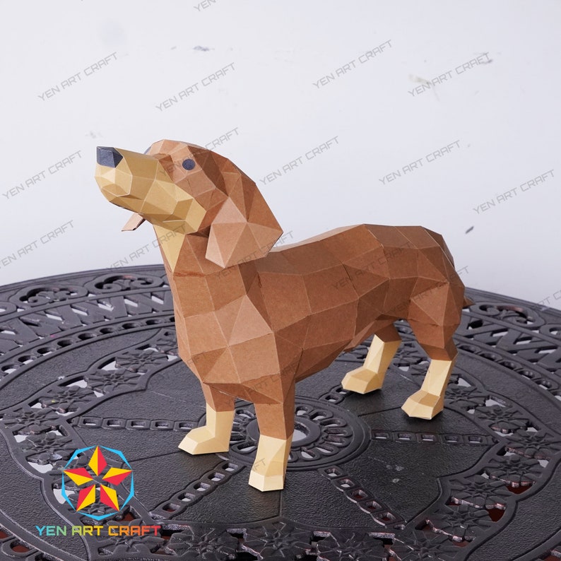 May include: A brown papercraft dachshund standing on a black metal table. The dachshund is made of many small triangles and is a 3D model.