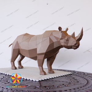 May include: A brown papercraft rhinoceros sculpture. The sculpture is made up of many small polygons and is standing on a white tiled surface.