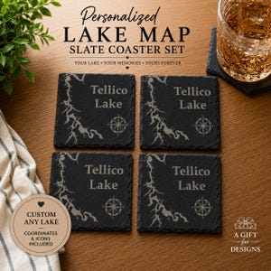 May include: A set of four square black slate coasters featuring an engraved map of Tellico Lake, the text Tellico Lake, and a compass rose icon. The coasters have a rough, natural edge texture and are arranged in a two-by-two grid pattern.