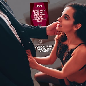 May include: A rectangular game card with a dark red background featuring the text Dare, CLOSE YOUR EYES AND OPEN YOUR MOUTH - 1 MINUTE FREE PLAY, and COMPLETE EACH DARE TO WIN A GAME! The card includes a small circular logo with a stylised figure.