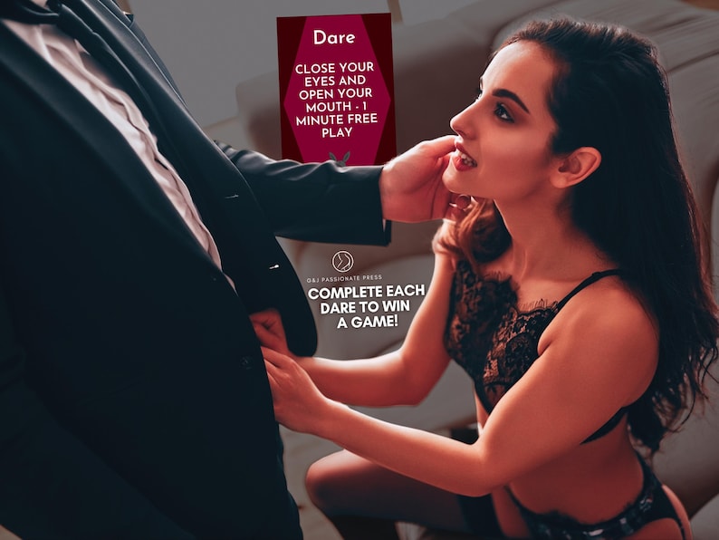 May include: A rectangular game card with a dark red background featuring the text Dare, CLOSE YOUR EYES AND OPEN YOUR MOUTH - 1 MINUTE FREE PLAY, and COMPLETE EACH DARE TO WIN A GAME! The card includes a small circular logo with a stylised figure.
