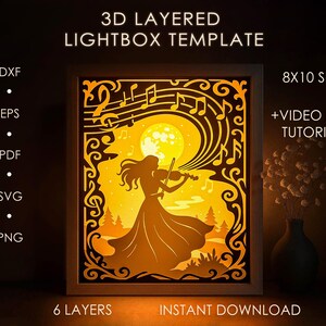 Puede incluir: Una plantilla de caja de luz 3D en capas que presenta una silueta de una persona tocando el violín bajo la luna llena, con notas musicales. El diseño está en un marco de madera, con el texto "3D Layered Lightbox Template" y "8x10 Size".