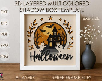May include: A framed 3D layered shadow box template with a Halloween theme. The design features a haunted house, bats, ghosts, and the word "Halloween". The artwork is in a white frame and is 8x8 inches in size.