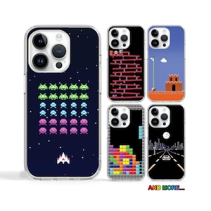 May include: Set of six iPhone cases with different pixelated designs. The cases feature retro video game themes, including space invaders, a brick-breaking game, and a platformer. The cases are all black and white with colorful accents.