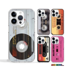 May include: A set of six clear phone cases with different retro cassette tape designs. The cases feature various colors and text, including "TDK", "MARSCORE", "MIAMI DRIVE", "GUARDIANS OF THE GALAXY", "POSITION CHROM", and "AWESOME MIX VOL. 1".