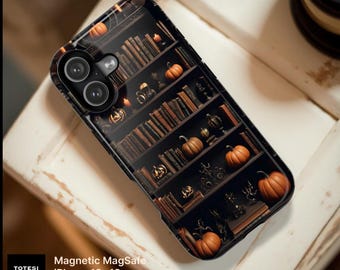 May include: A black phone case featuring a printed design of dark wooden bookshelves filled with old books, small orange pumpkins, and lit candles. The case includes a dual camera cutout and text reading Totesi Design, Magnetic MagSafe, iPhone 18-13, Samsung S26.