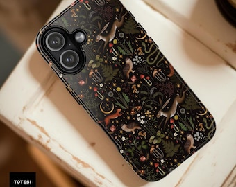 May include: Black phone case with a whimsical forest pattern featuring hares, foxes, mushrooms, and ferns. The case has a glossy finish and a camera cutout. The text "TOTESI DESIGN" is in a white box in the lower left corner.