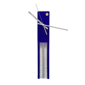May include: A modern, rectangular wall clock with a deep blue face and silver hands. The clock has a unique, minimalist design with a clear, vertical section at the bottom. A small, round sticker is visible near the top.