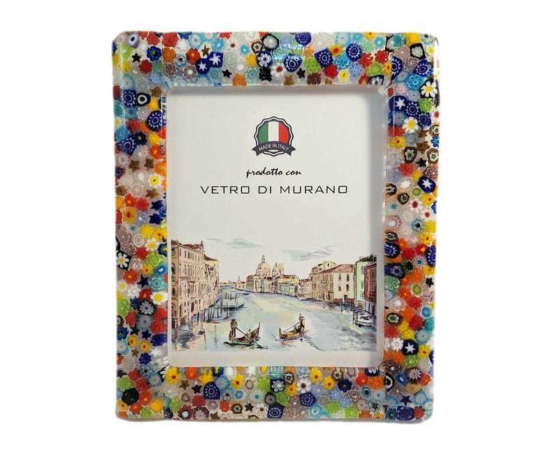 May include: Rectangular photo frame with a colorful mosaic border. The frame's edge is adorned with a vibrant mix of floral and geometric glass pieces in various colors. The frame features a picture of a canal scene and the text "prodotto con VETRO DI MURANO".