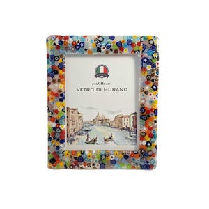 May include: A rectangular picture frame with a colorful mosaic border. The frame's edge is adorned with a vibrant pattern of small, multicolored glass pieces. The frame holds a picture of a canal scene, with the text "prodotte con VETRO DI MURANO".
