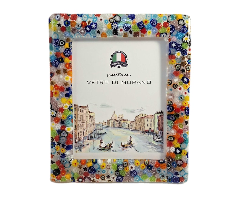 May include: A rectangular photo frame with a colorful mosaic border. The frame's edge is adorned with a vibrant mix of floral and geometric patterns in various colors. The frame holds a picture of a canal scene with gondolas and buildings. The text "prodotto con VETRO DI MURANO" is visible.
