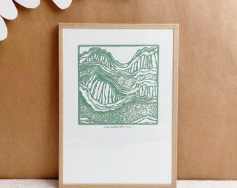 May include: A framed green and white print of a stylized mountain landscape. The print is titled "little panorama - min."