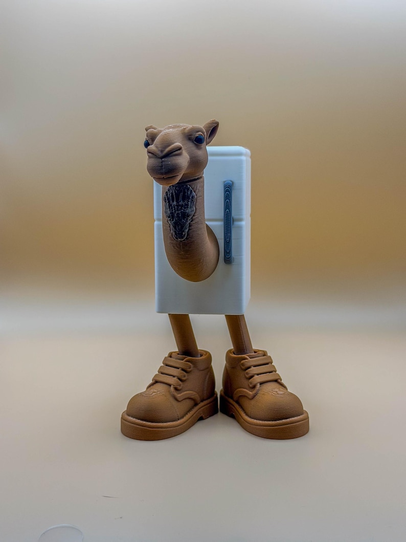 May include: A whimsical 3D-printed sculpture of a camel with a white refrigerator body, brown legs, and brown shoes. The camel's head is detailed with a dark tattoo on its neck. The sculpture is set against a neutral background.