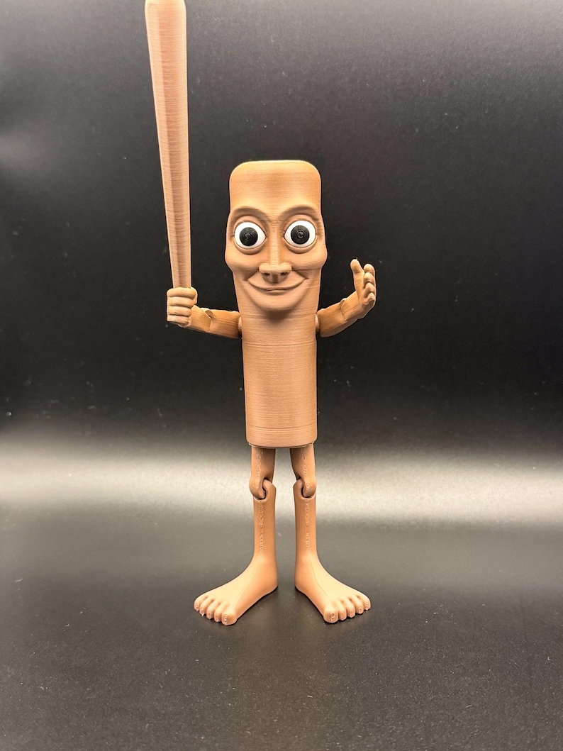 May include: A brown, 3D-printed figurine of a cartoon character holding a baseball bat. The figure has a rectangular body, large eyes, and a smiling face. It has articulated legs and feet, and is posed with one arm raised.