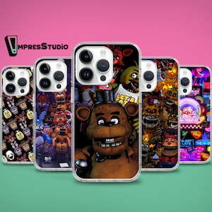 May include: Five different phone cases featuring various characters from the Five Nights at Freddy's video game franchise. The cases are clear and show the characters in a collage style. The characters include Freddy Fazbear, Bonnie the Bunny, Chica the Chicken, Foxy the Pirate Fox, and Golden Freddy.