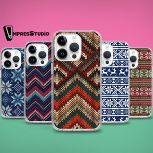 May include: Five different phone cases with wintery patterns. The cases are clear and show the phone's camera lenses. The patterns include snowflakes, reindeer, and geometric designs.