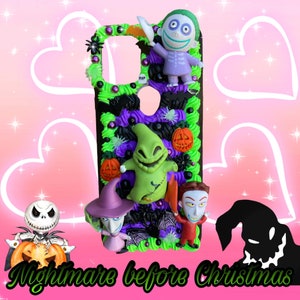 May include: A decorative phone case featuring characters from "The Nightmare Before Christmas." The case is adorned with green, purple, and black accents, and includes figures of Jack Skellington, Oogie Boogie, and others. The text "Nightmare before Christmas" is also visible.