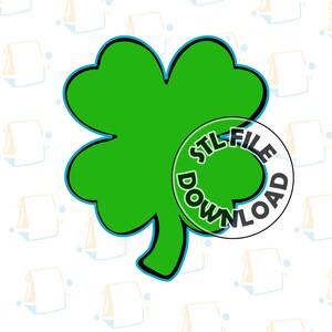 Puede incluir: Un trébol de cuatro hojas verde con un contorno azul. El trébol es un archivo STL imprimible en 3D.