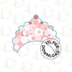 May include: A pink and white crown with a blue outline. The crown is made of circles and is shaped like a half-circle. The text "STL FILE DOWNLOAD" is in a circle below the crown.