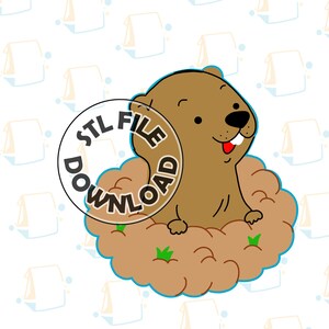 May include: A brown cartoon groundhog with a toothy grin sits in a brown dirt mound with green grass. The groundhog is surrounded by a blue circle with the text "STL FILE DOWNLOAD" in white.