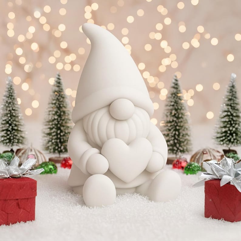 May include: A white ceramic gnome figurine holding a heart, surrounded by miniature Christmas trees and red gift boxes with silver bows. The background features soft, blurred lights, creating a festive holiday scene.